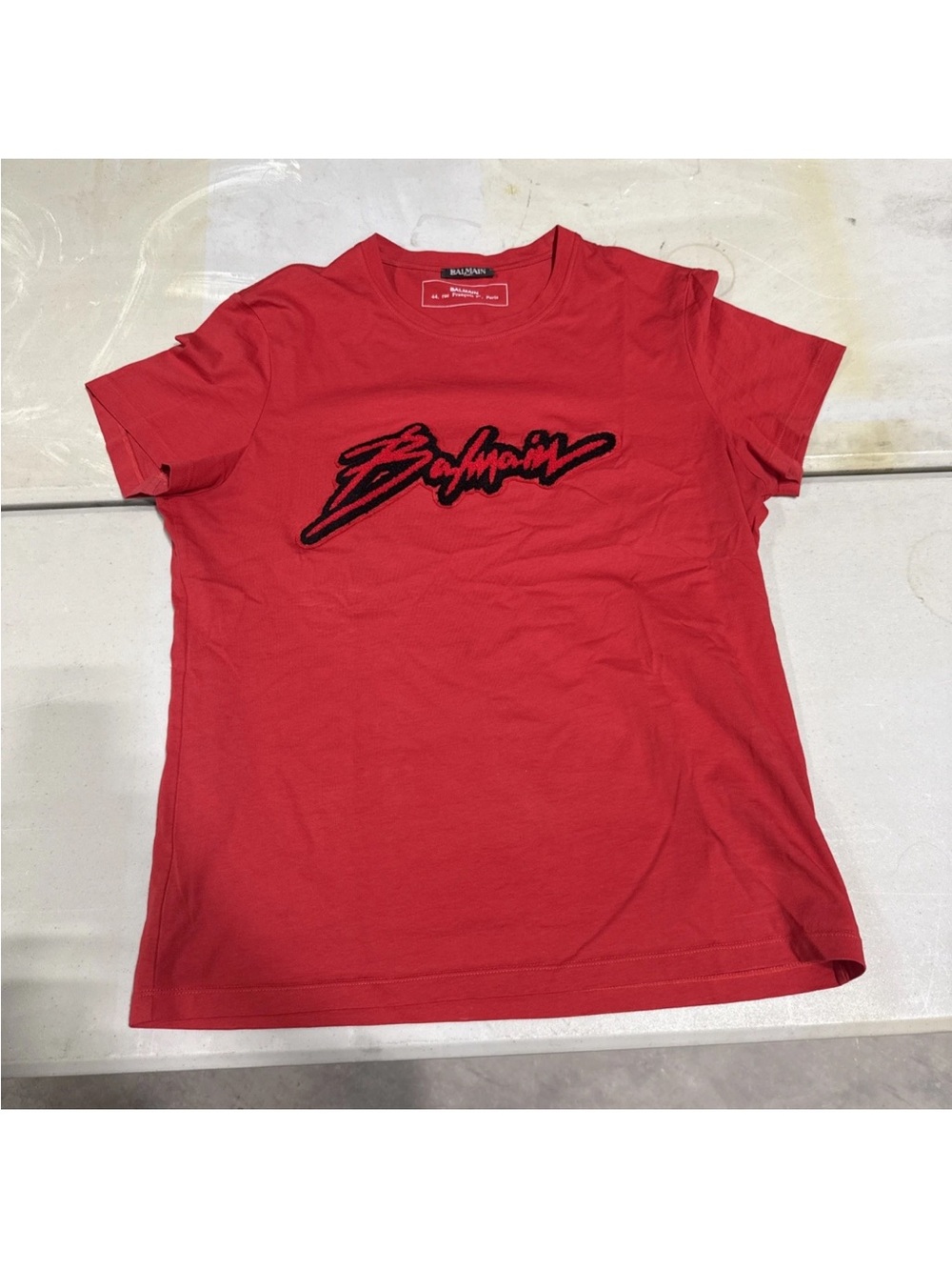Balmain Red Tee with raised Black Script Balmain Logo size L to Xl comfy fit